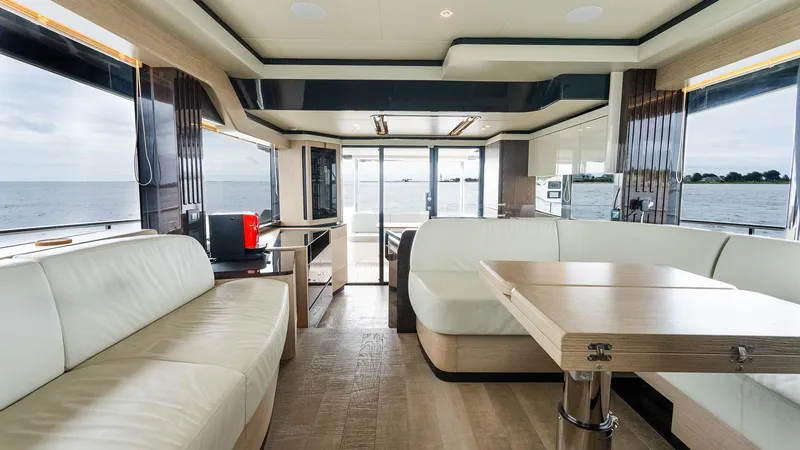 The Transporter Yacht Photos Pics Luxurious interior of 2023 Absolute 52 Navetta yacht with modern seating and ocean view.