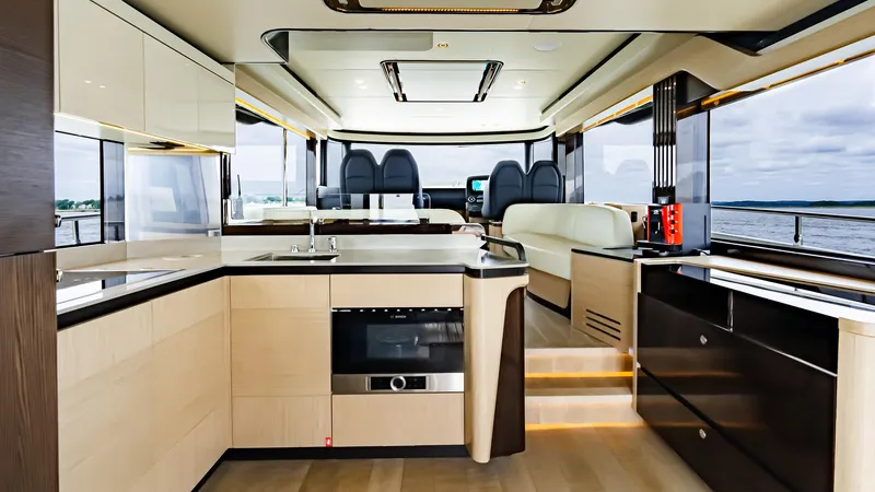 The Transporter Yacht Photos Pics Luxurious interior of 2023 Absolute 52 Navetta yacht with modern kitchen and panoramic windows.