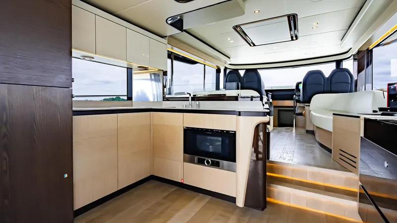 The Transporter Yacht Photos Pics Luxurious interior of 2023 Absolute 52 Navetta yacht with modern kitchen and seating area.