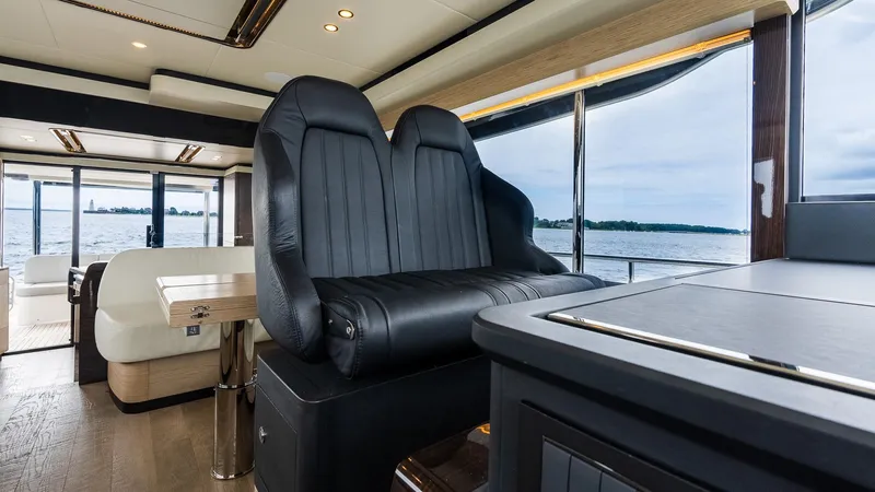 The Transporter Yacht Photos Pics Luxurious interior of 2023 Absolute 52 Navetta yacht with black leather seating.