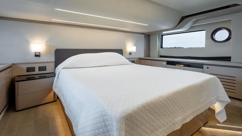 The Transporter Yacht Photos Pics Luxurious bedroom interior of 2023 Absolute 52 Navetta yacht, featuring modern design and elegant furnishings.