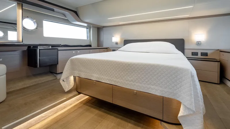 The Transporter Yacht Photos Pics Luxurious bedroom interior of 2023 Absolute 52 Navetta yacht, featuring modern design and elegant furnishings.