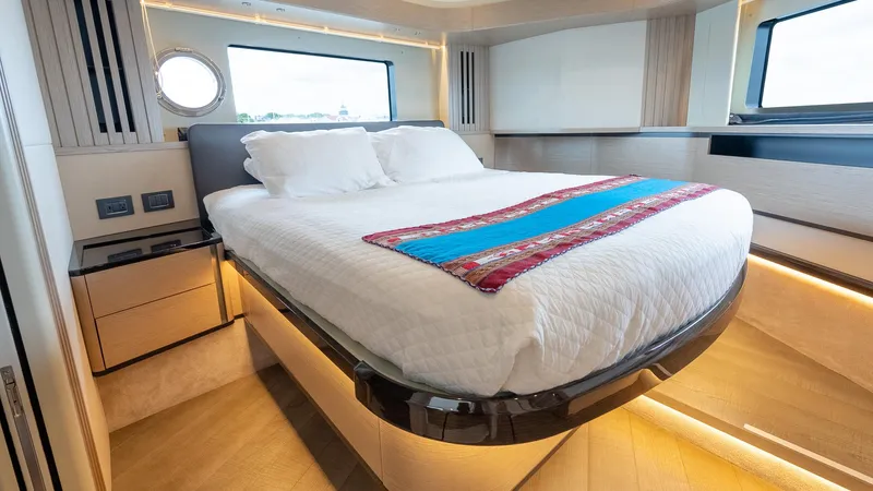 The Transporter Yacht Photos Pics Luxurious bedroom interior of 2023 Absolute 52 Navetta yacht with modern design and elegant lighting.