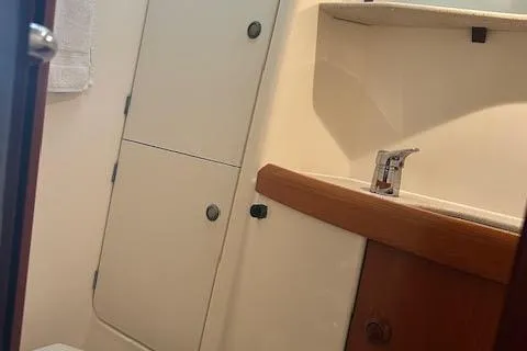 Nonna Yacht Photos Pics 2005 Jeanneau Deck Salon 43 bathroom with sink, storage cabinets, and towel rack.