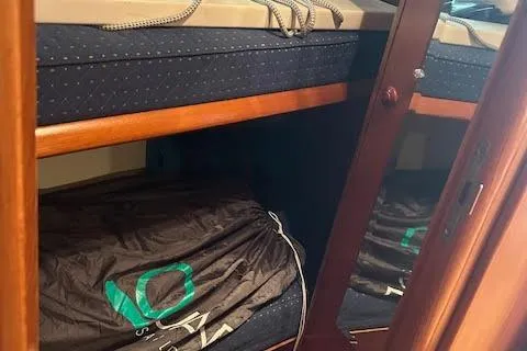 Nonna Yacht Photos Pics 2005 Jeanneau Deck Salon 43 interior with wooden cabinetry and storage space.