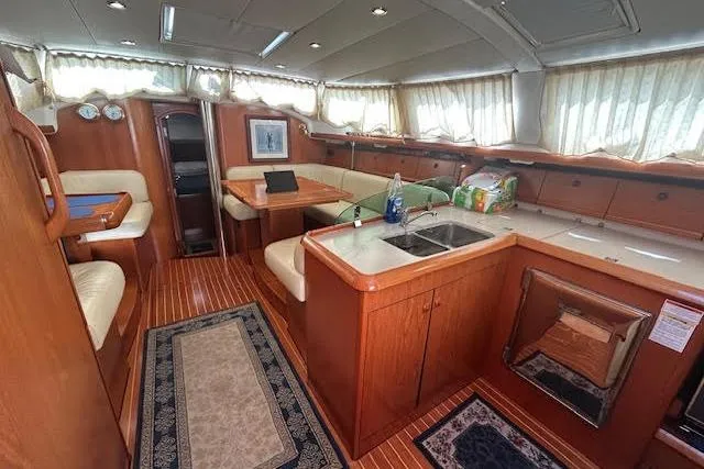 Nonna Yacht Photos Pics Interior of 2005 Jeanneau Deck Salon 43 yacht with wood finish and spacious seating.