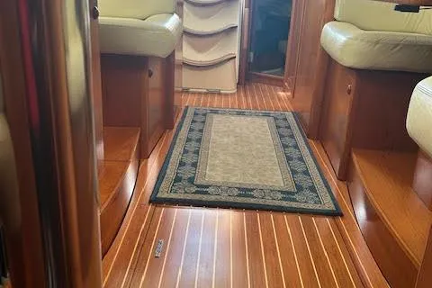 Nonna Yacht Photos Pics Interior of 2005 Jeanneau Deck Salon 43 with wood flooring and seating.