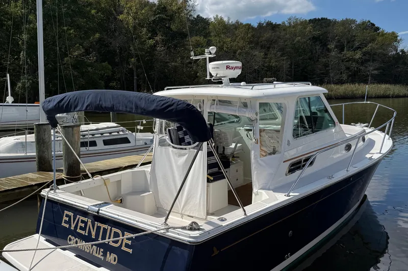 Eventide Yacht Photos Pics 2007 Back Cove 29 boat docked, featuring a navy hull and white cabin, named "Eventide."