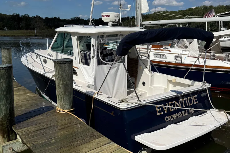 Eventide Yacht Photos Pics 2007 Back Cove 29 boat docked, featuring a navy hull and white cabin.