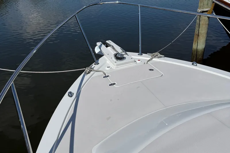 Eventide Yacht Photos Pics 2007 Back Cove 29 boat bow with anchor, docked on calm water.