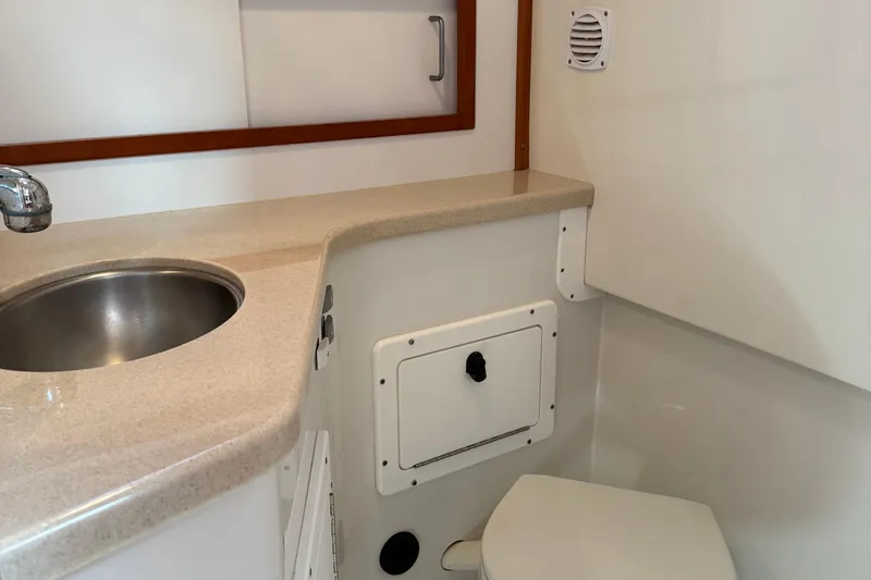 Eventide Yacht Photos Pics 2007 Back Cove 29 boat bathroom with sink, countertop, and storage compartment.