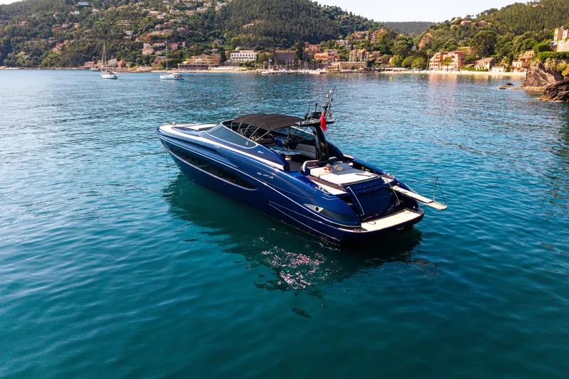 Yacht Photos Pics Luxurious 2015 Riva 63 Virtus yacht cruising in scenic coastal waters.