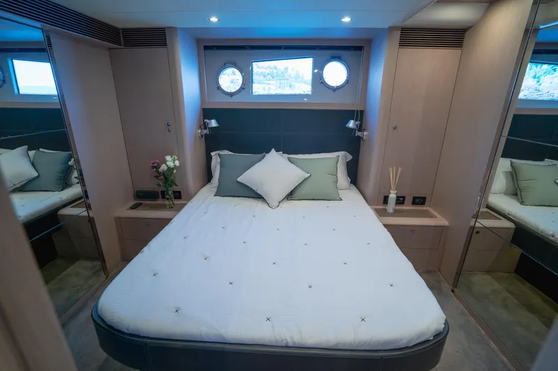  Yacht Photos Pics Luxurious bedroom interior of 2015 Riva 63 Virtus yacht with elegant decor and porthole window.