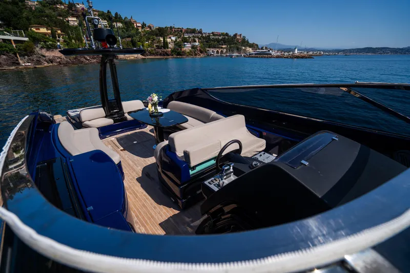  Yacht Photos Pics Luxurious 2015 Riva 63 Virtus yacht interior with elegant seating, overlooking serene coastal waters.