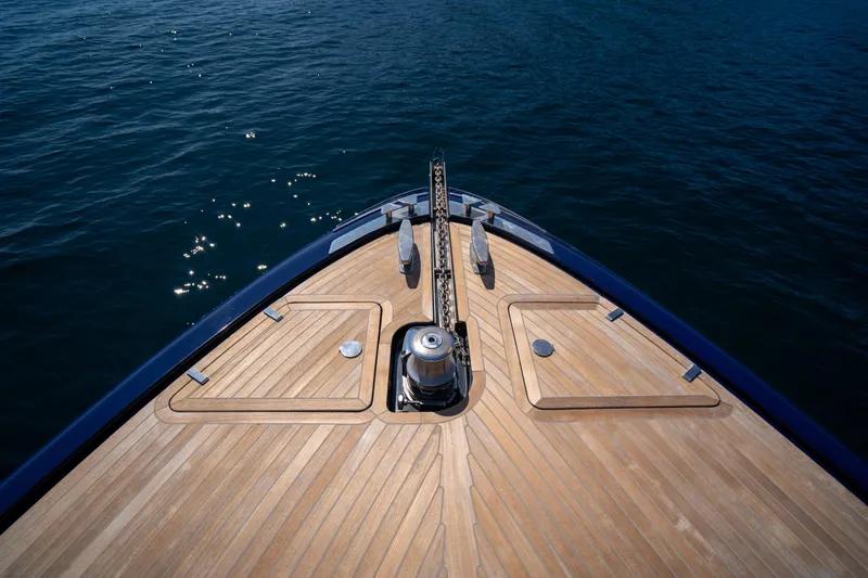  Yacht Photos Pics Bow of 2015 Riva 63 Virtus yacht with teak deck on calm water.