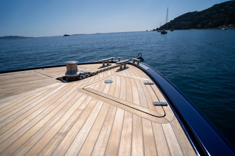  Yacht Photos Pics Bow of 2015 Riva 63 Virtus yacht with wooden deck on calm sea.
