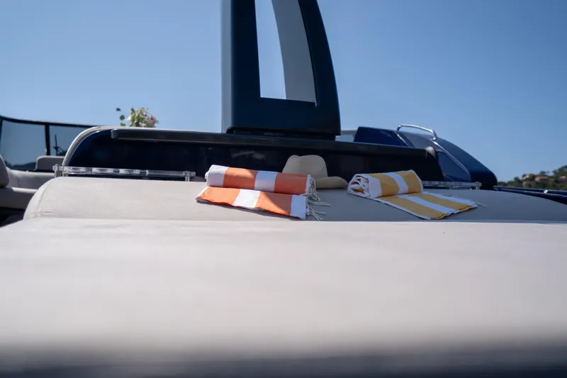  Yacht Photos Pics 2015 Riva 63 Virtus yacht with striped towels and hat on deck.