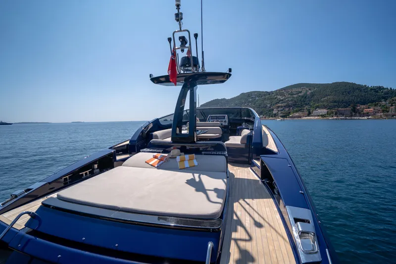  Yacht Photos Pics Luxurious 2015 Riva 63 Virtus yacht on serene waters with scenic coastal backdrop.
