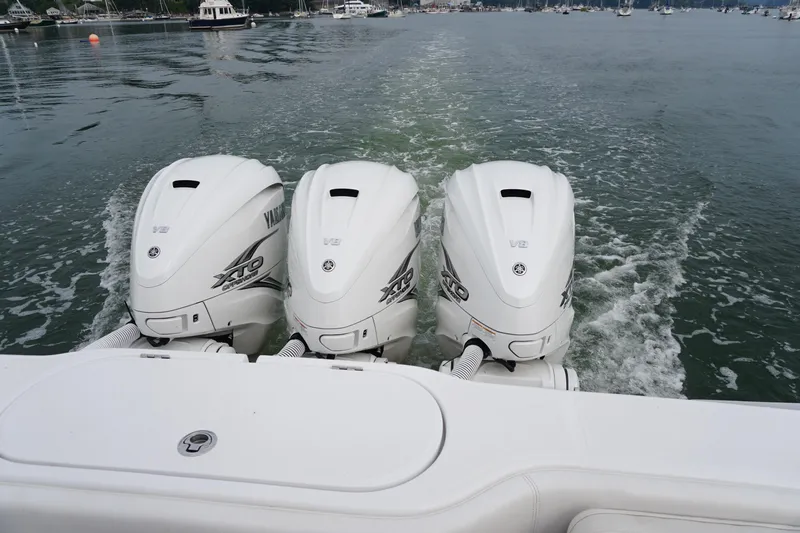  Yacht Photos Pics Triple Yamaha XTO outboard engines on a 2021 Jupiter 41 SB boat in calm waters.