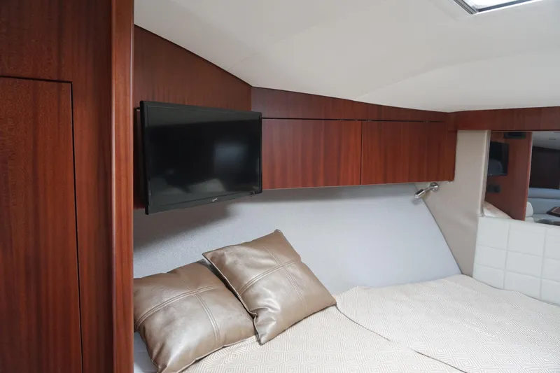  Yacht Photos Pics Luxurious interior of 2021 Jupiter 41 SB yacht with TV and elegant bedding.