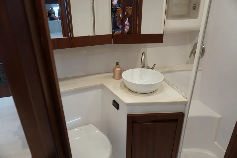  Yacht Photos Pics Modern bathroom in 2021 Jupiter 41 SB yacht with vessel sink and wooden cabinetry.