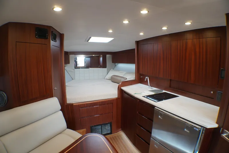  Yacht Photos Pics Luxurious interior of 2021 Jupiter 41 SB yacht with wood finish and modern amenities.