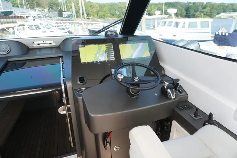  Yacht Photos Pics Helm of 2021 Jupiter 41 SB boat with navigation screens and steering wheel.