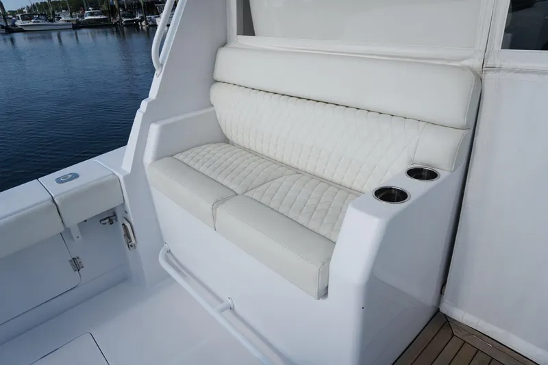  Yacht Photos Pics Luxurious seating on 2021 Jupiter 41 SB boat with quilted upholstery and cup holders.