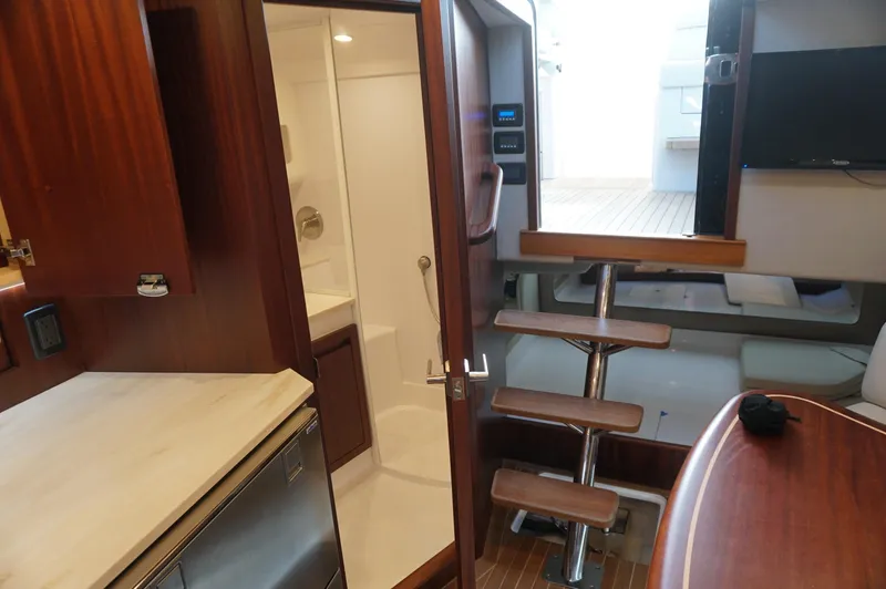  Yacht Photos Pics Interior of 2021 Jupiter 41 SB yacht with wooden stairs and kitchenette.