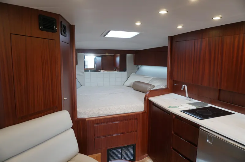  Yacht Photos Pics Interior of 2021 Jupiter 41 SB yacht with wood finish and kitchenette.