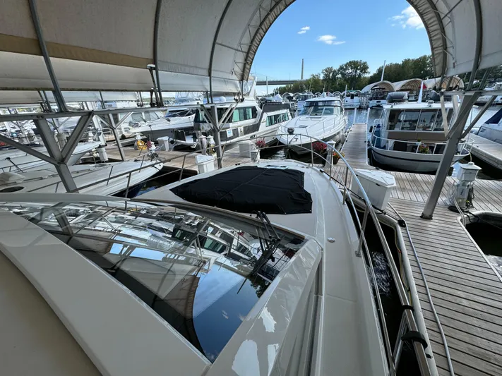 Yacht Rock Yacht Photos Pics 2015 Cruisers Yachts 390 Express Coupe docked in a marina under a canopy.