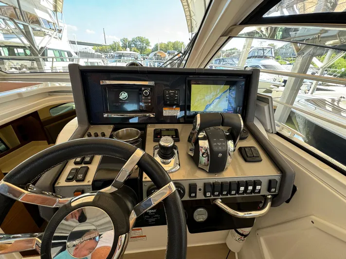 Yacht Rock Yacht Photos Pics Helm of 2015 Cruisers Yachts 390 Express Coupe with navigation screens and controls.