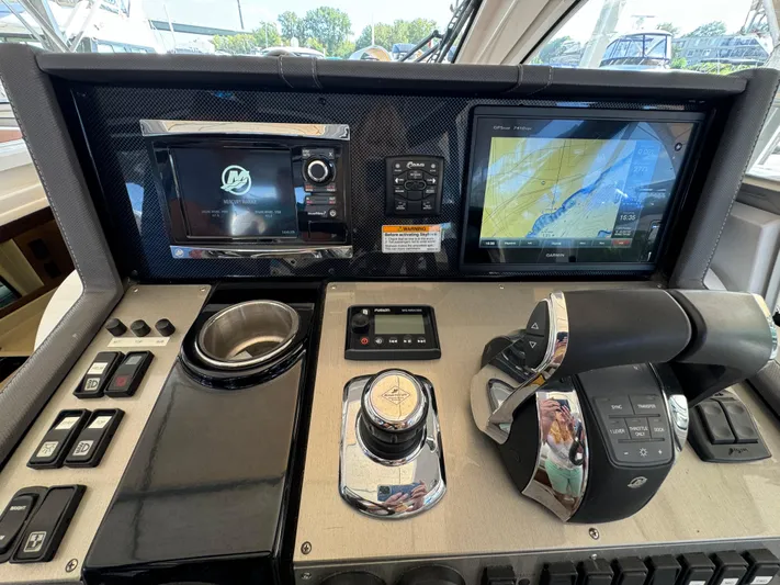 Yacht Rock Yacht Photos Pics Control panel of 2015 Cruisers Yachts 390 Express Coupe with navigation screens and controls.