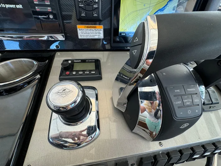 Yacht Rock Yacht Photos Pics Control panel of 2015 Cruisers Yachts 390 Express Coupe with navigation and throttle controls.