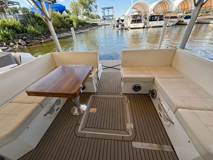 Yacht Rock Yacht Photos Pics 2015 Cruisers Yachts 390 Express Coupe interior with seating and table, docked at marina.