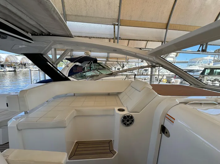 Yacht Rock Yacht Photos Pics 2015 Cruisers Yachts 390 Express Coupe interior with white seating and marina view.