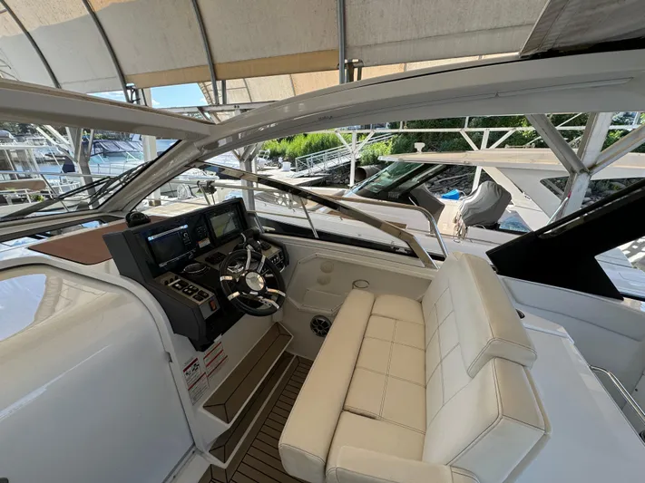 Yacht Rock Yacht Photos Pics 2015 Cruisers Yachts 390 Express Coupe helm with leather seating and modern controls.