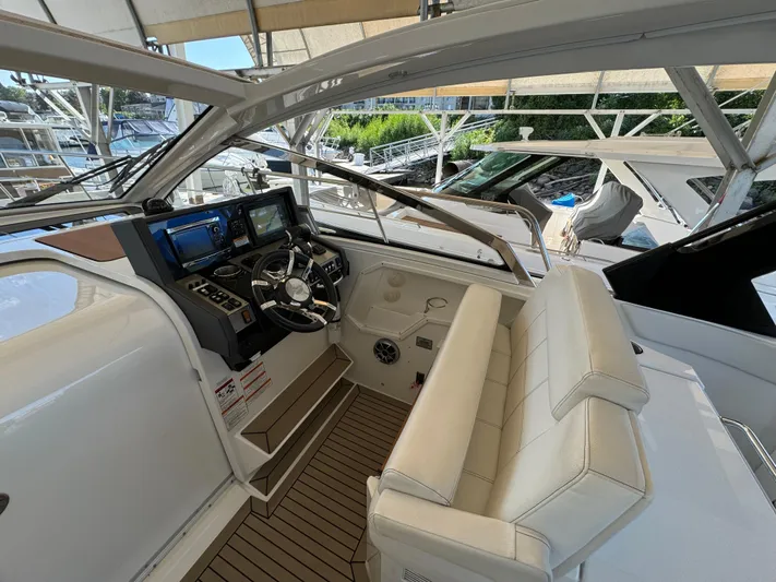 Yacht Rock Yacht Photos Pics 2015 Cruisers Yachts 390 Express Coupe helm with modern controls and white seating.