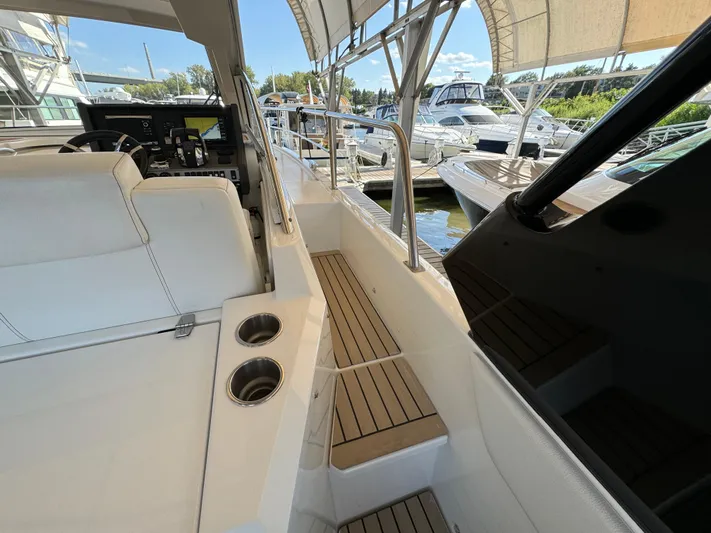 Yacht Rock Yacht Photos Pics 2015 Cruisers Yachts 390 Express Coupe interior with helm, seating, and docked boats.