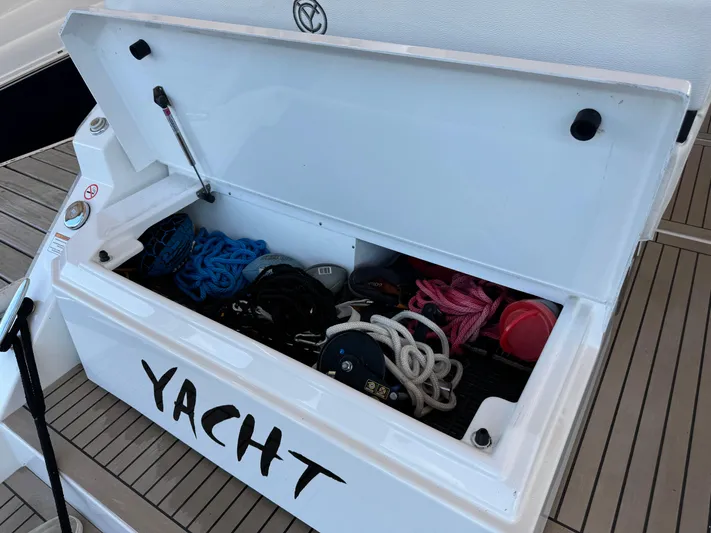 Yacht Rock Yacht Photos Pics Open storage compartment on 2015 Cruisers Yachts 390 Express Coupe, containing ropes and equipment.