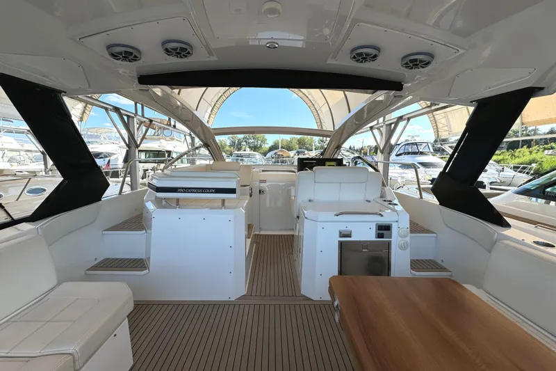 Yacht Rock Yacht Photos Pics 2015 Cruisers Yachts 390 Express Coupe interior with seating, table, and helm station.