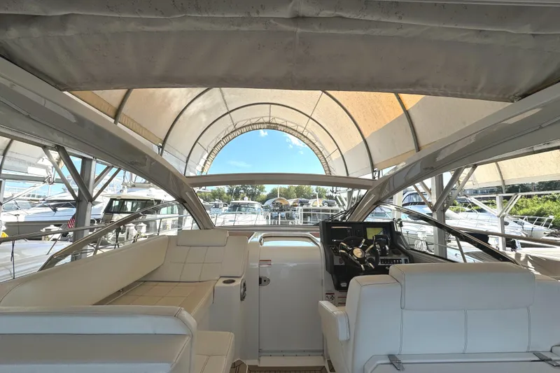 Yacht Rock Yacht Photos Pics 2015 Cruisers Yachts 390 Express Coupe interior with helm and seating under canopy.