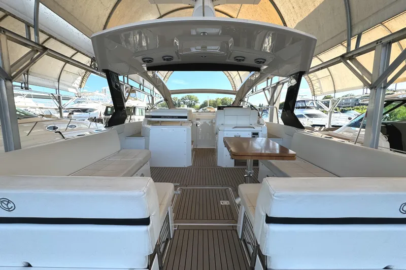 Yacht Rock Yacht Photos Pics 2015 Cruisers Yachts 390 Express Coupe interior with white seating and wooden table.