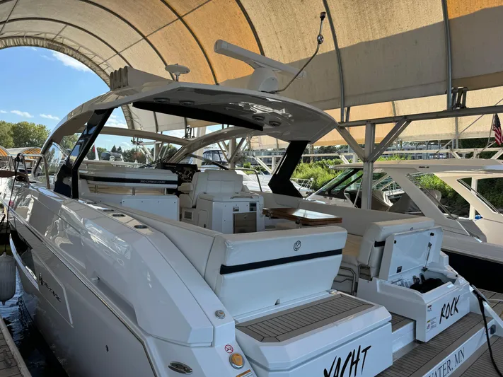 Yacht Rock Yacht Photos Pics 2015 Cruisers Yachts 390 Express Coupe docked under a canopy.