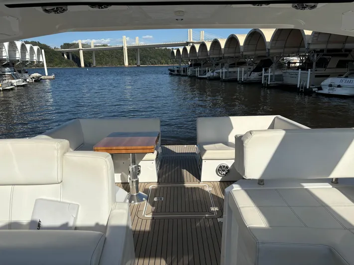 Yacht Rock Yacht Photos Pics 2015 Cruisers Yachts 390 Express Coupe interior with white seating, wooden table, and waterfront view.