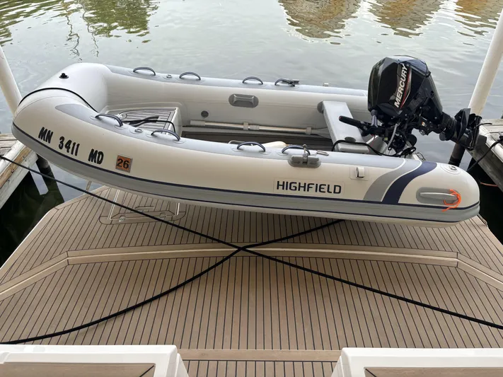 Yacht Rock Yacht Photos Pics Inflatable boat on dock with outboard motor, near water, labeled "Highfield."