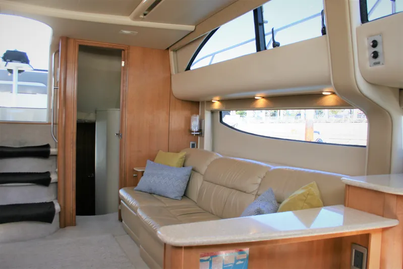 Embracing Life Yacht Photos Pics Interior of 2004 Meridian 459 Motoryacht with beige leather seating and wooden accents.
