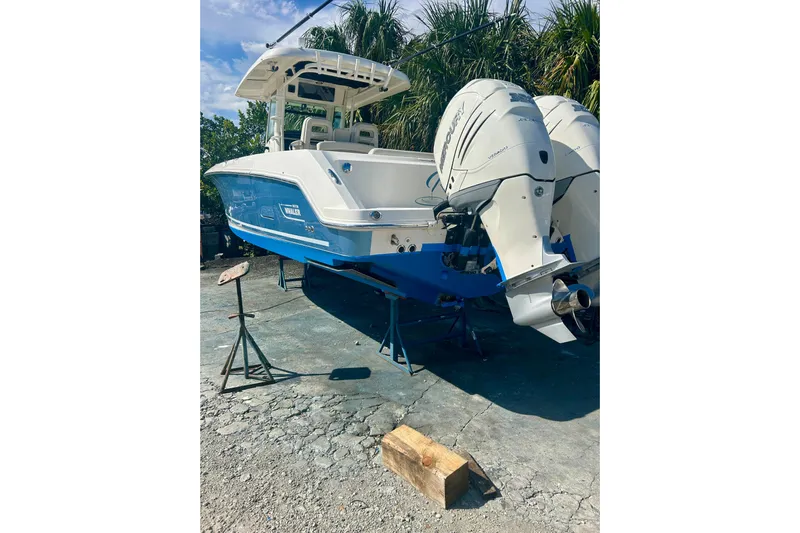 Overtime Yacht Photos Pics 2018 Boston Whaler 330 Outrage boat with dual Mercury engines on a stand.