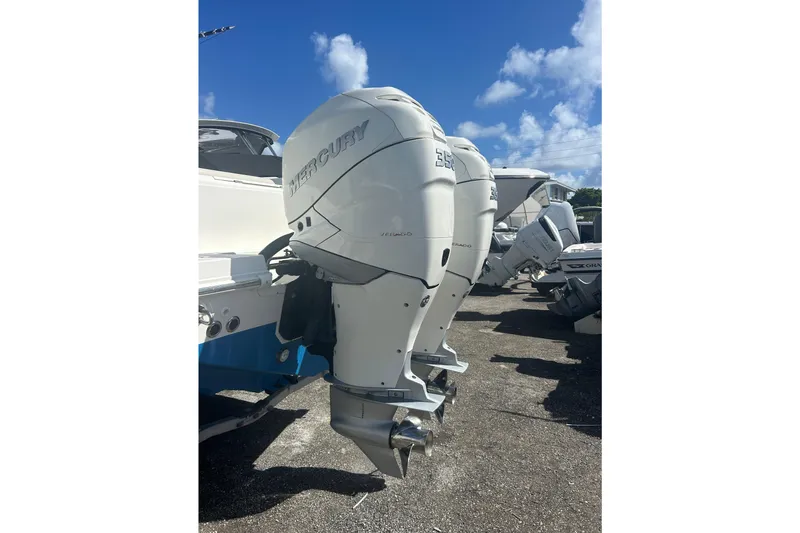 Overtime Yacht Photos Pics Twin Mercury outboard engines on a 2018 Boston Whaler 330 Outrage under a clear blue sky.