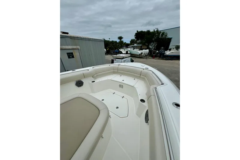 Overtime Yacht Photos Pics 2018 Boston Whaler 330 Outrage boat deck with seating, docked outdoors.